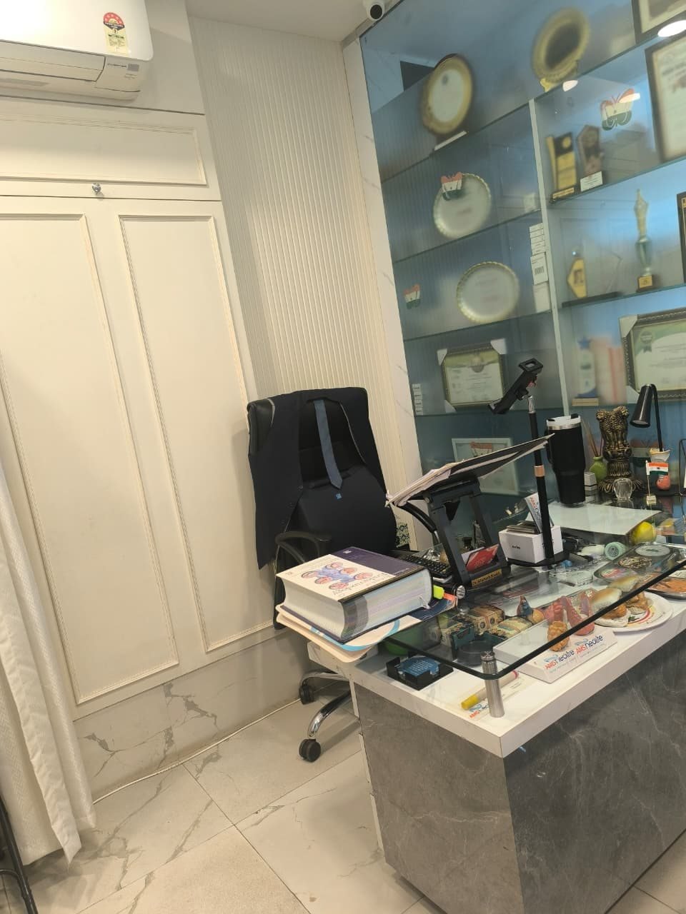 Consultant's desk with professional recognitions at AMS Neolife